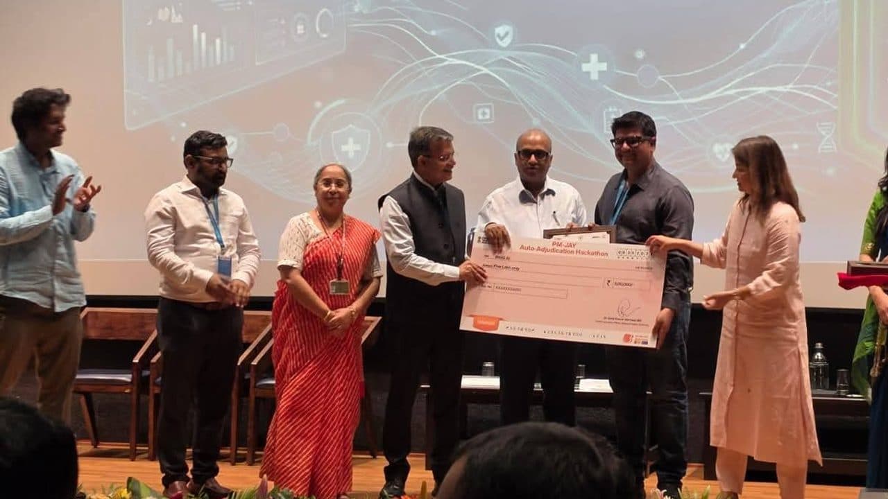 The BiltIQ AI team receiving the winner's cheque at the NHA PM-JAY Auto-Adjudication Hackathon 2026 finale, IISc Bangalore